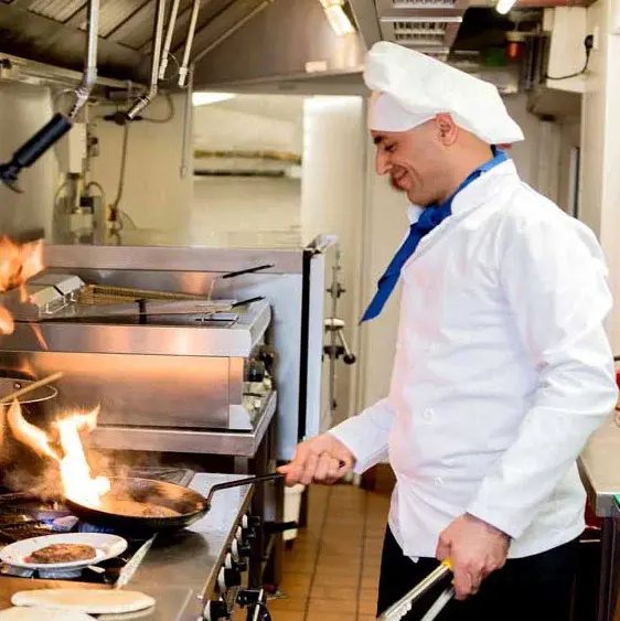 The Lodge at Wake Forest Chef Created Meals, chef frying a dish.