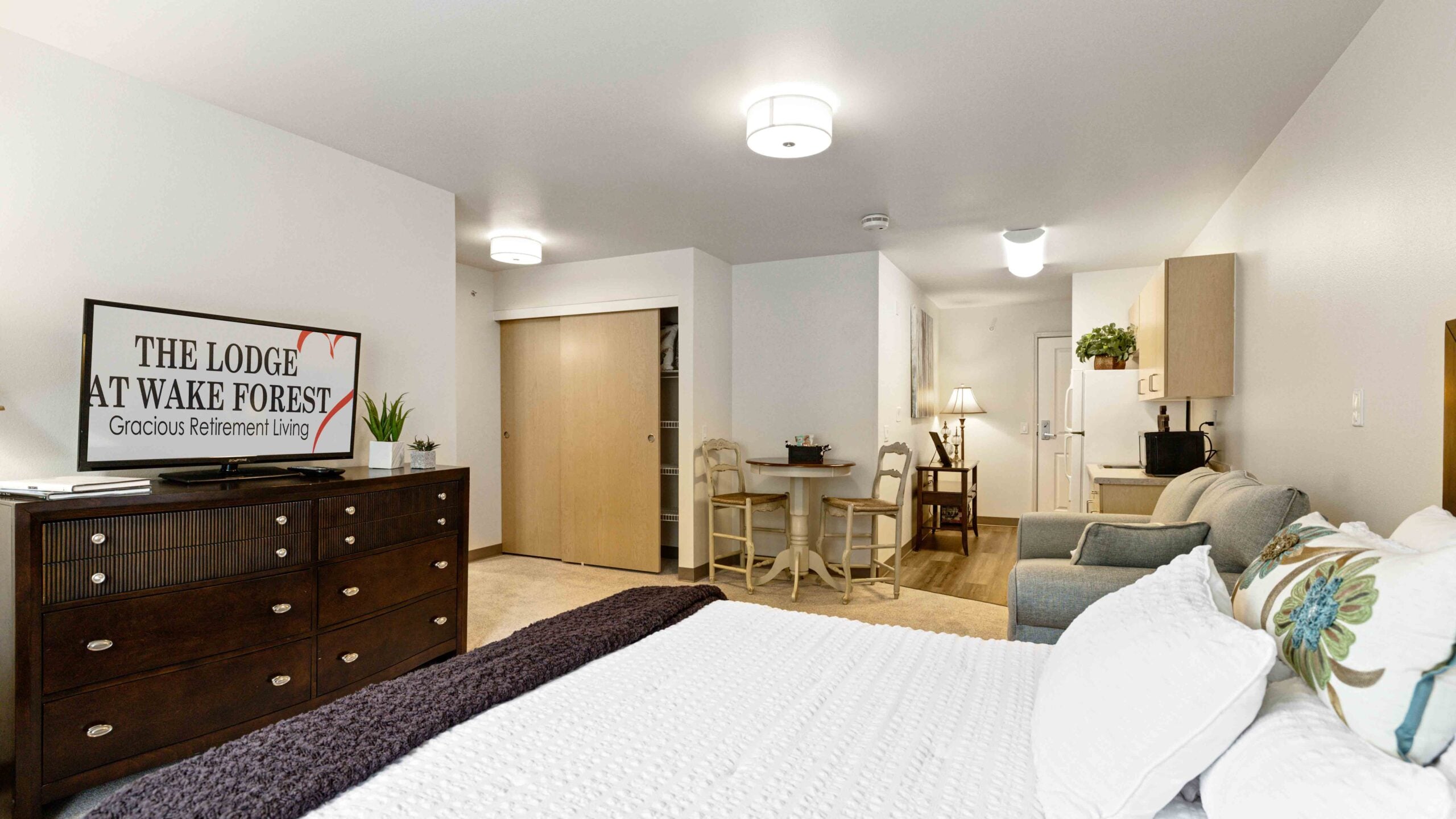 A furnished bedroom in a The Lodge at Wake Forest apartment