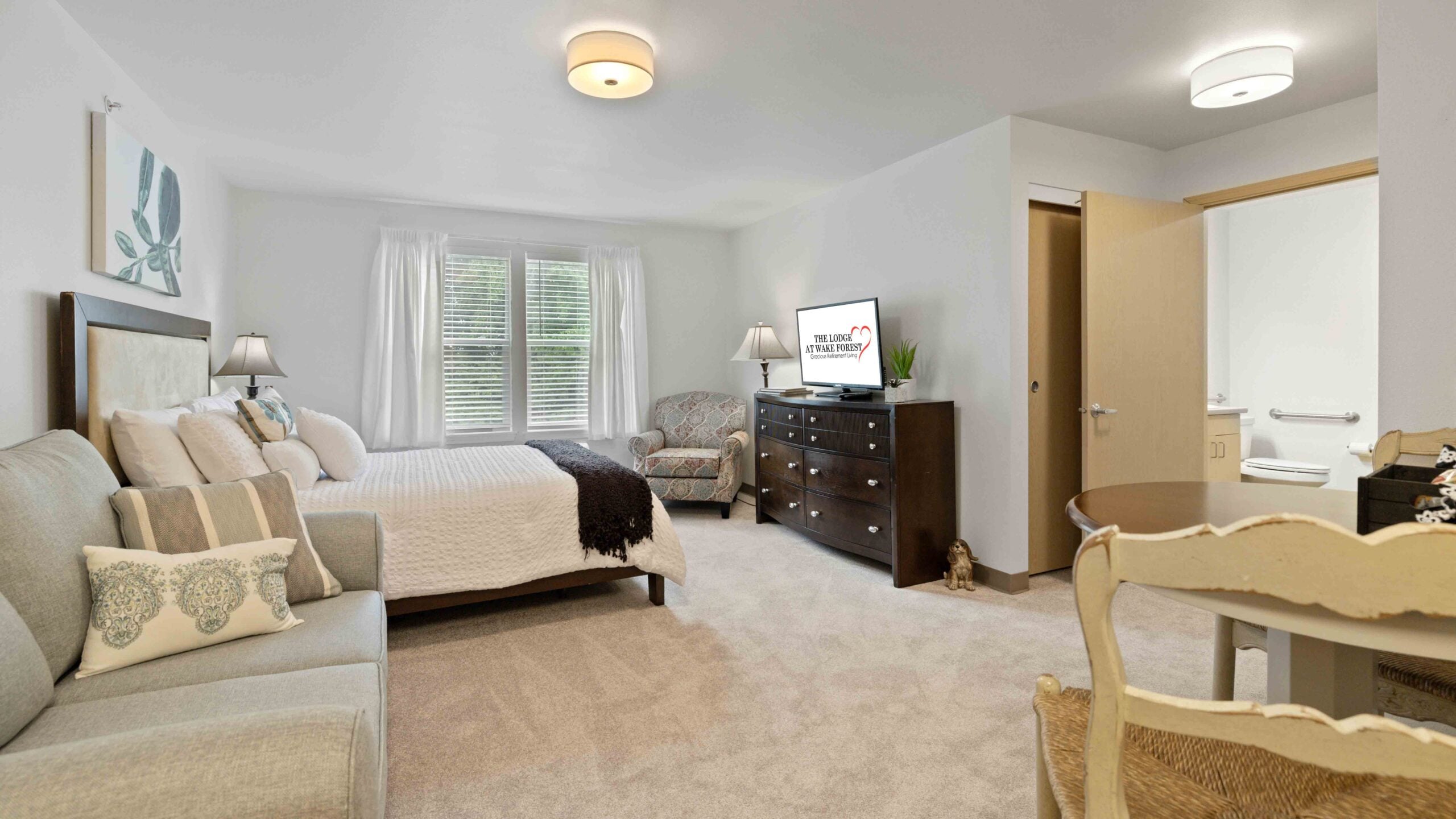 A furnished bedroom in a The Lodge at Wake Forest apartment